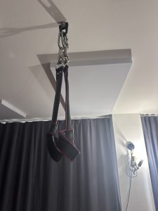 Gepolsterte Manschetten an einer Deckenaufhängung im BDSM-Studio